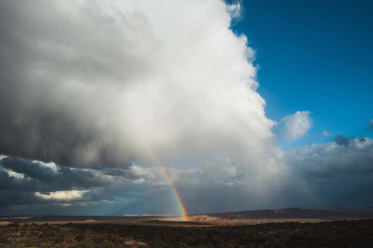 united states rainbow under cloudy skies moab